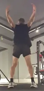 showing the Arm Crossover Swings exercise from the rear