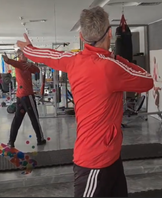 showing the Chest Spin Warm-up gym exercise