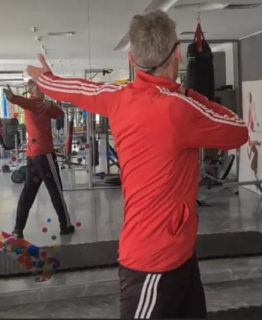 showing the Chest Spin Warm-up gym exercise