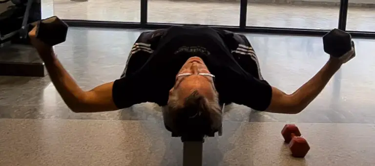 showing the Flat Bench Dumbbell Fly gym exercise