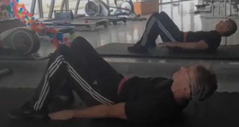 Showing the Heel Touch Pilates exercise