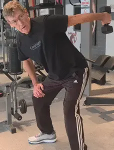Showing the Tricep Kickback exercise using a single dumbbell