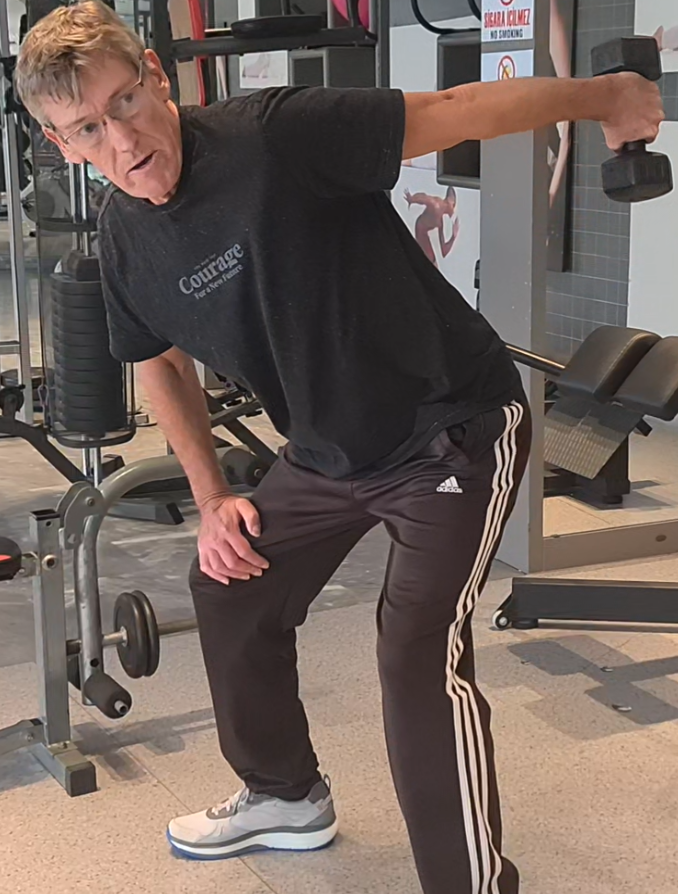 Showing the Tricep Kickback exercise using a single dumbell