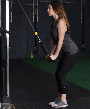 Showing the form of the Tricep Pulldown using a cable machine