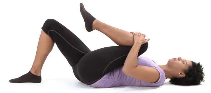 Showing how to do the Single Knee Hug Pilates exercise