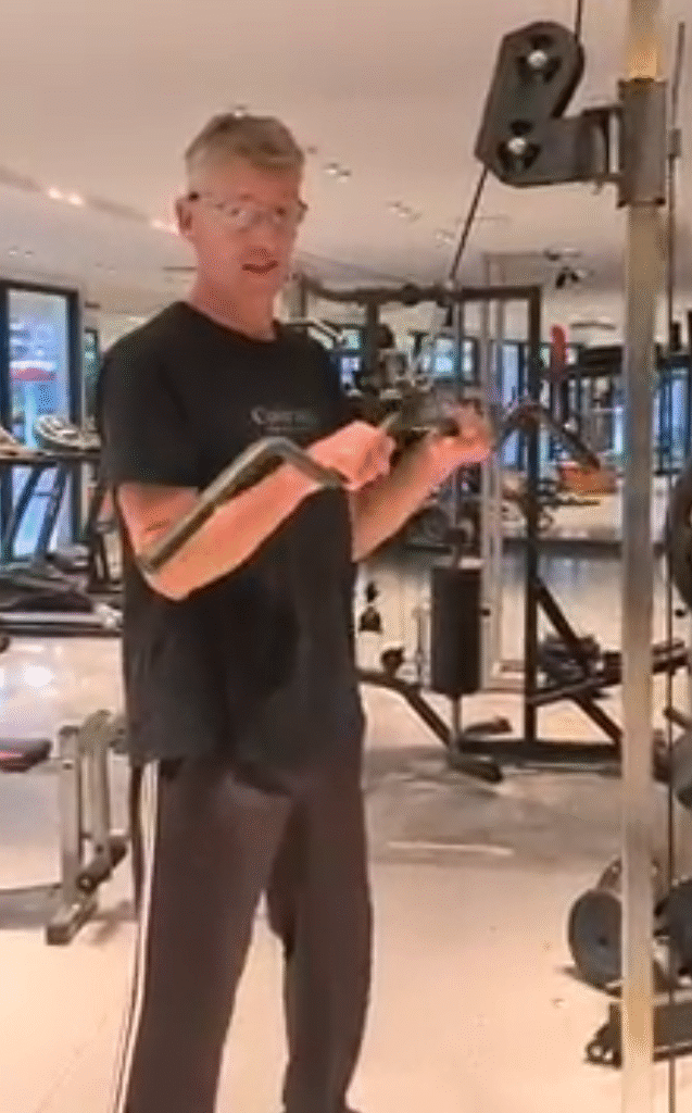 showing the Tricep Pulldown exercise at the top position