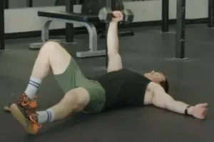Showing the start position for the Turkish Getup dumbbell exercise