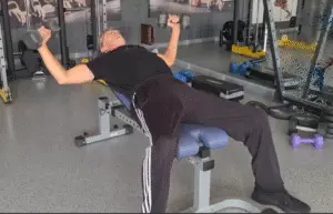 Showing a still image from the Incline Dumbbell Fly video - a gym exercise to build the Upper Chest Muscles
