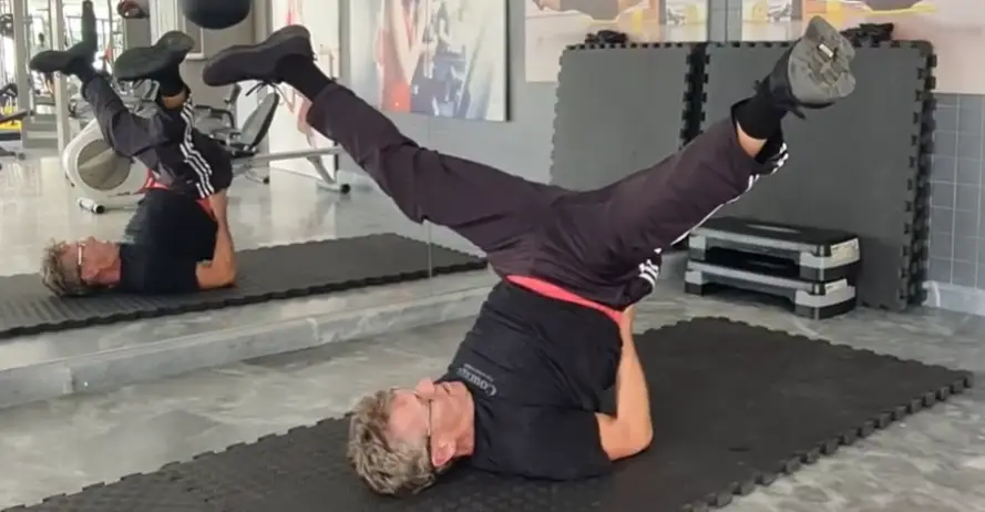 Showing the Legs Up Lying Scissors Stretch exercise
