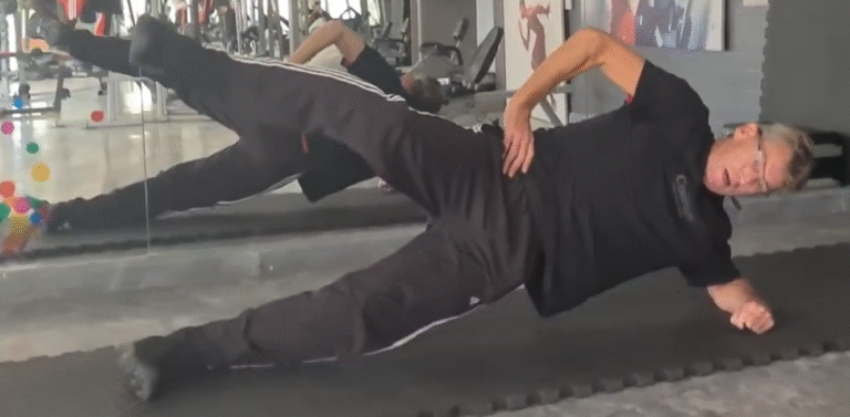 Showing the Side Plank Scissors Pilates exercise form