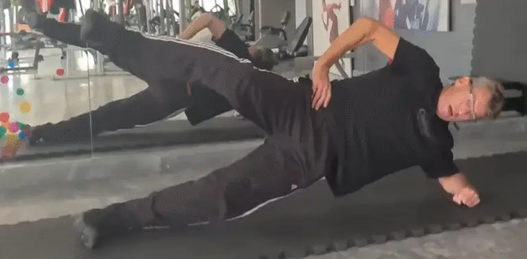 Showing the Side Plank Scissors Pilates exercise form