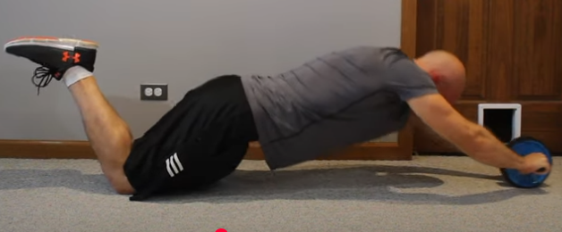 Showing the Ab Wheel Roll gym exercise
