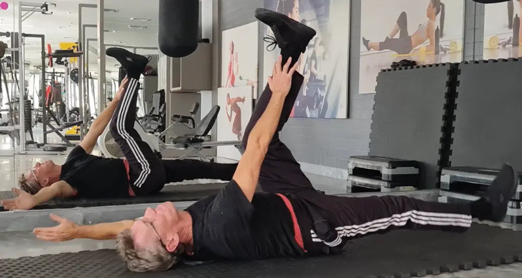 Showing the Dead Bug Pilates exercise