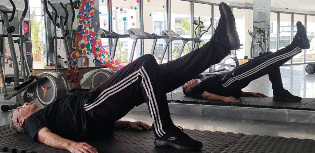 Showing Mojoh doing the Single Leg Bridge Pilates exercise