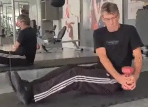 Shows a still image of the Russian Twist exercise from my videos giving Abs Pilates Lessons